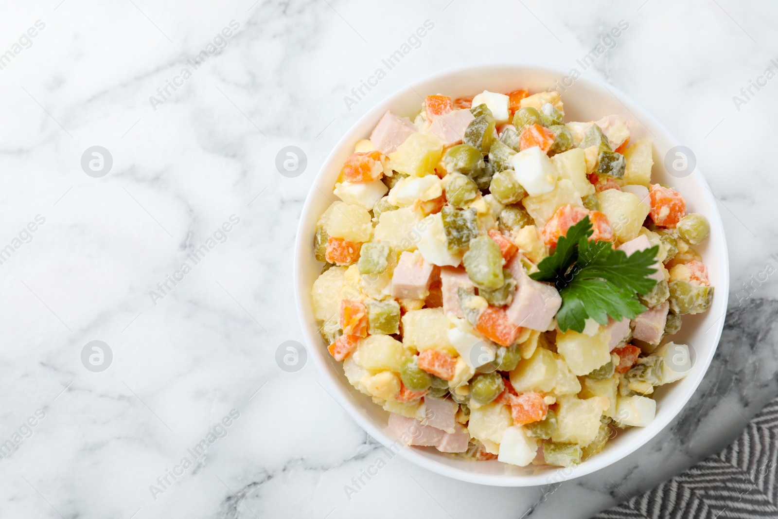 Photo of Delicious salad Olivier on marble table, top view. Space for text