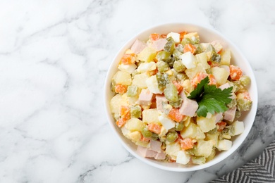 Photo of Delicious salad Olivier on marble table, top view. Space for text