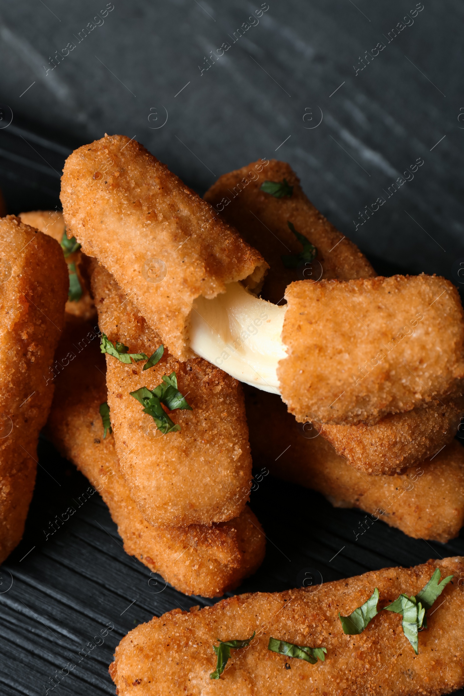 Photo of Pile of tasty cheese sticks on table, closeup