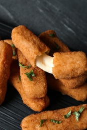 Photo of Pile of tasty cheese sticks on table, closeup