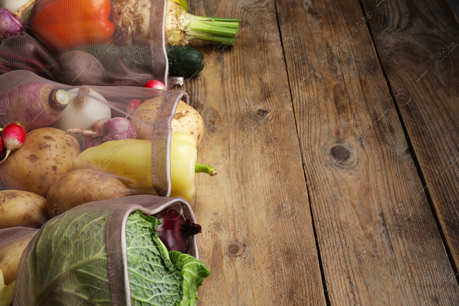 Photo of Different fresh ripe vegetables on wooden table. Space for text