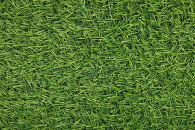 Photo of Green artificial grass as background, top view