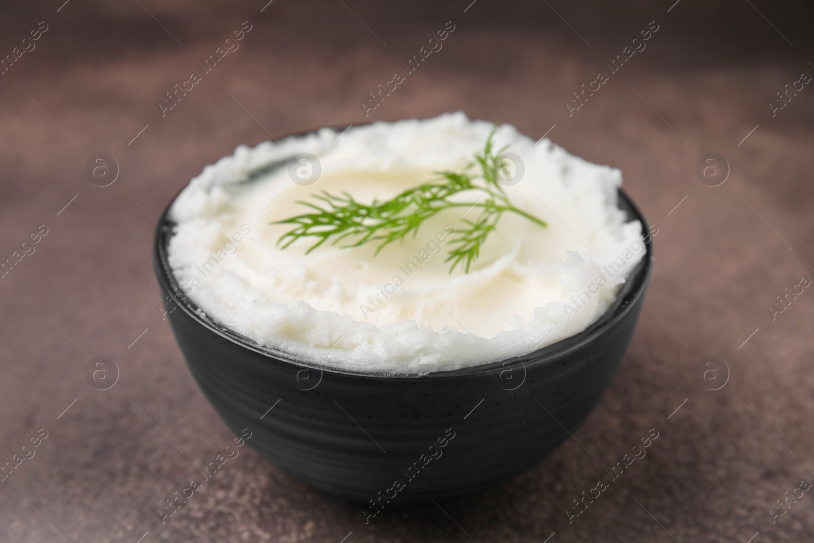 Photo of Delicious pork lard with dill in bowl on brown table