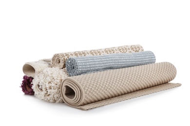 Photo of Different rolled carpets on white background. Interior element