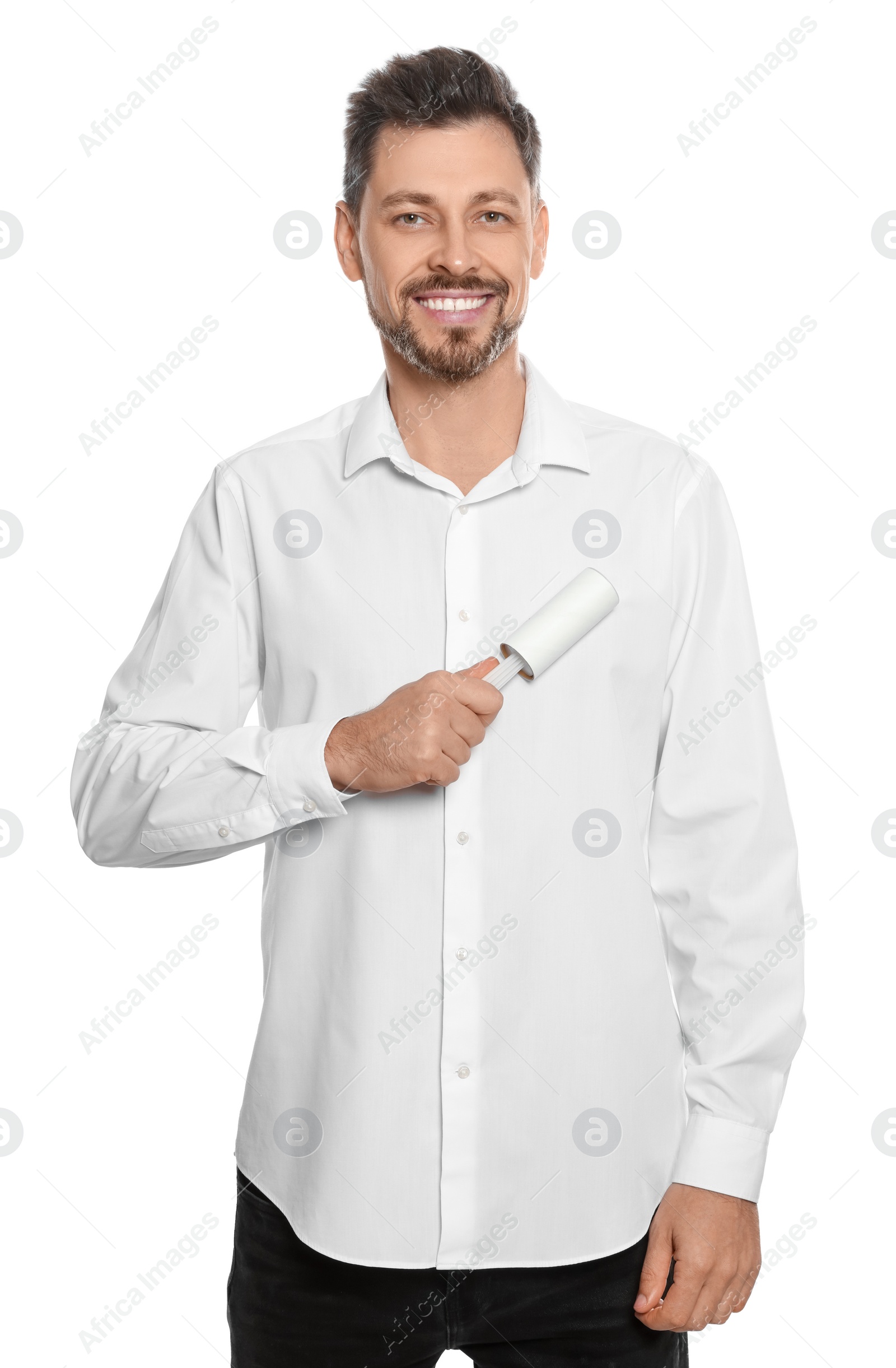 Photo of Handsome man cleaning shirt with adhesive lint roller on white background