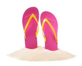 Photo of Pink flip flops in sand on white background