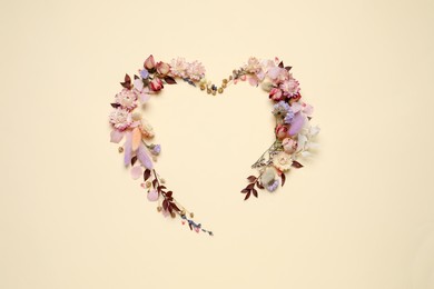 Photo of Beautiful heart shaped floral composition on beige background, flat lay