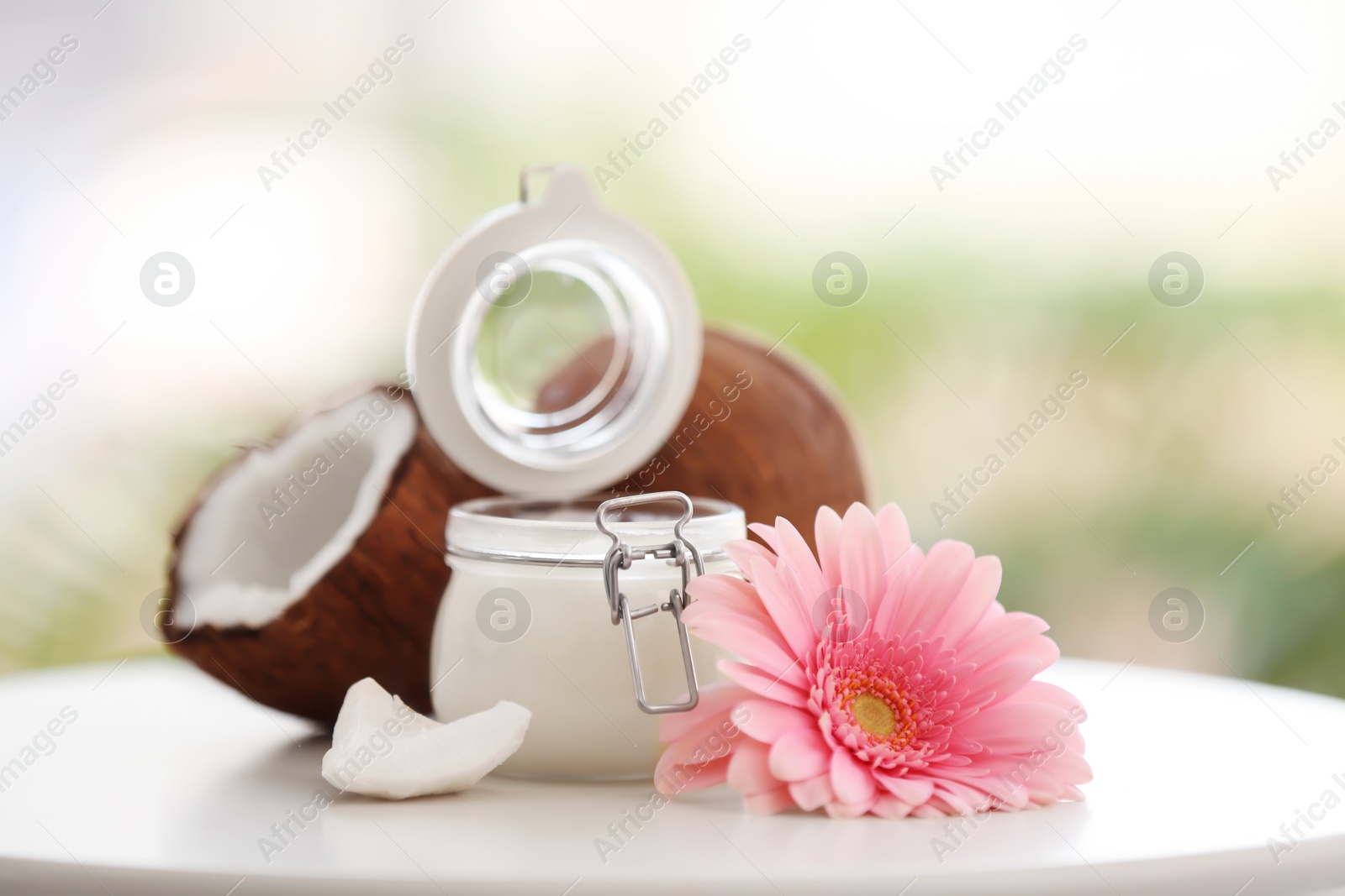 Photo of Composition with coconut butter in glass jar on blurred background