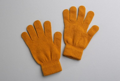 Photo of Pair of stylish woolen gloves on light grey background, flat lay