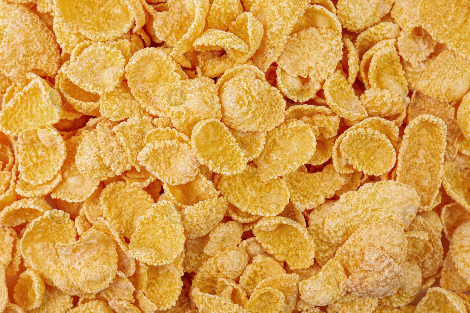 Photo of Sweet tasty corn flakes as background, top view