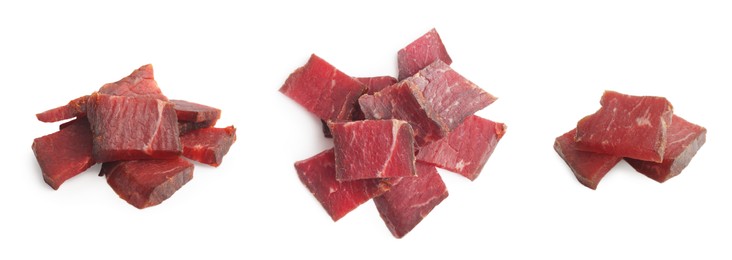 Set with delicious beef jerky on white background, top view. Banner design