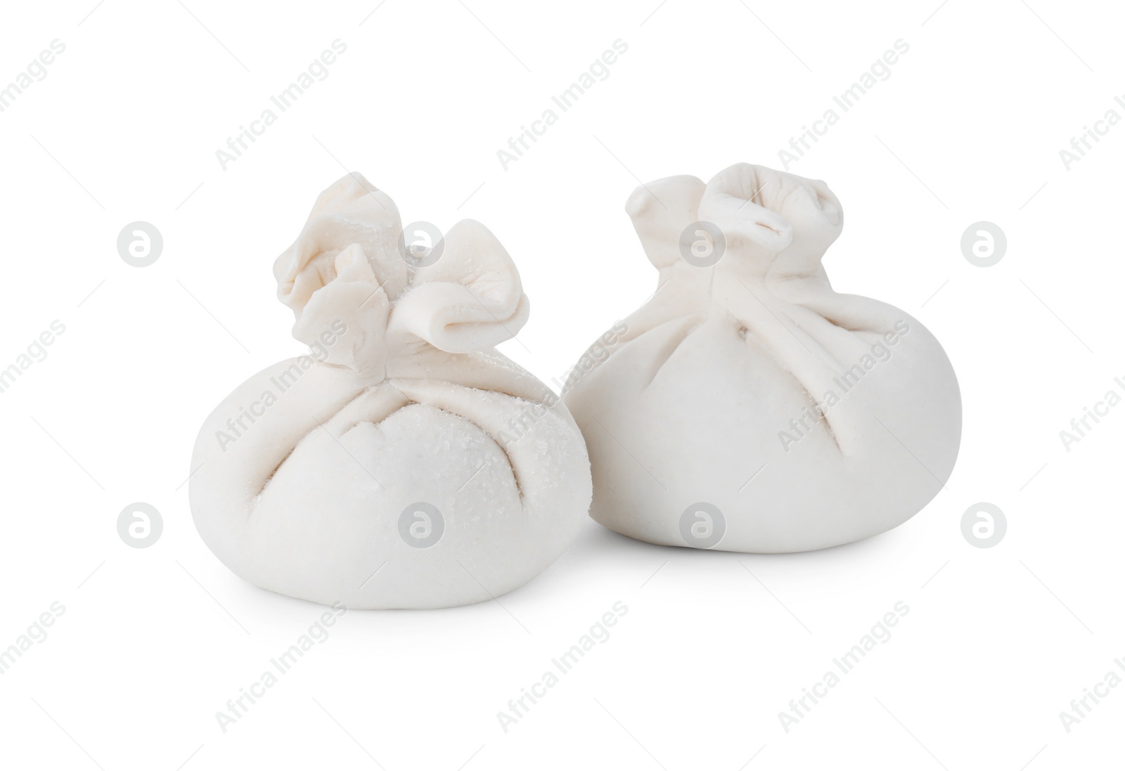 Photo of Uncooked khinkali (dumplings) isolated on white. Georgian cuisine