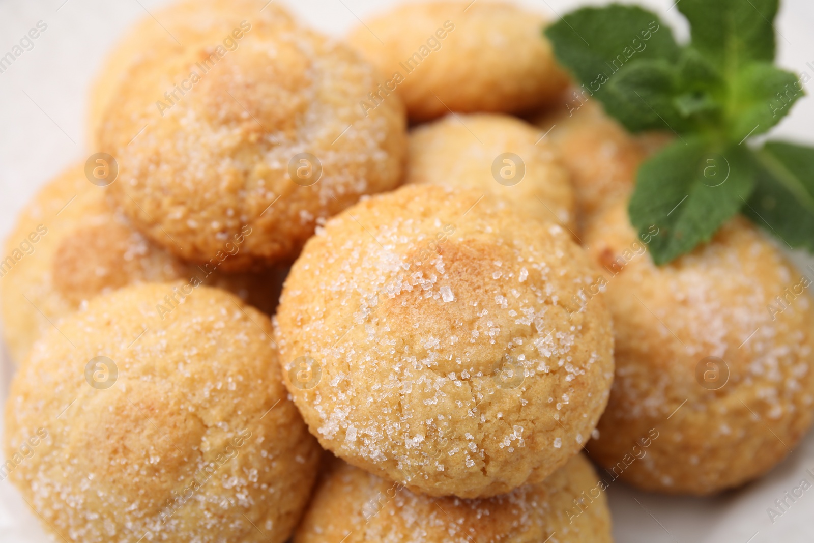 Photo of Tasty sweet sugar cookies and mint on plate, closeup