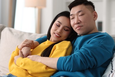 Photo of Happy young couple on sofa at home