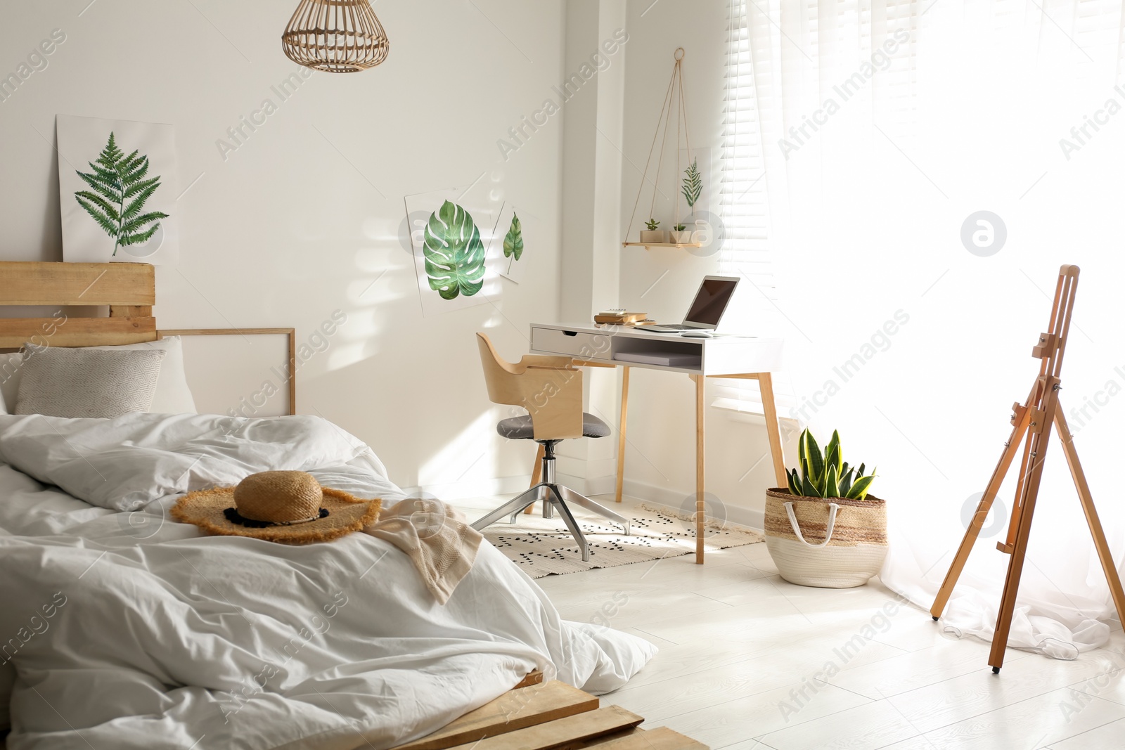 Photo of Stylish room interior with workplace and bed