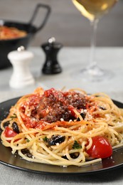 Photo of Delicious pasta with meatballs and tomato sauce served on table, closeup
