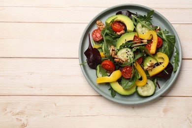 Photo of Balanced diet and vegetarian foods. Plate with different delicious products on wooden table, top view. Space for text