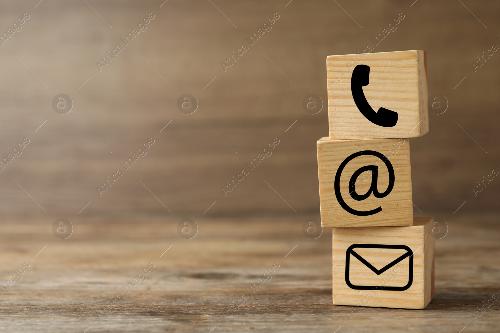 Image of Hotline service. Cubes with icons on wooden background, space for text