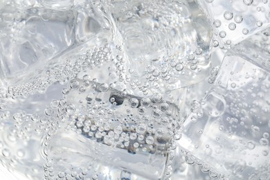 Photo of Soda water with ice as background, closeup