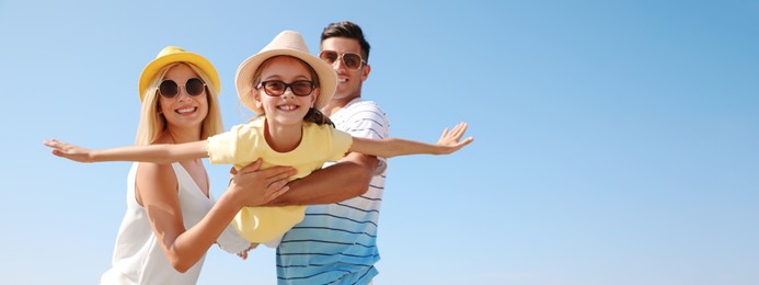 Parents playing with daughter outdoors, space for text. Banner design