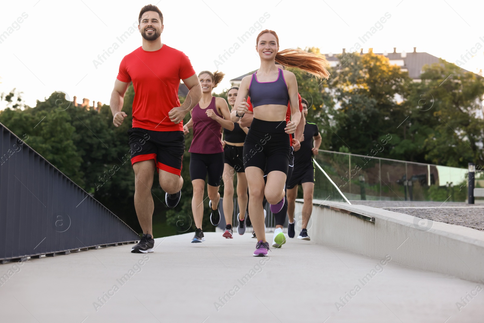 Photo of Group of people running outdoors. Active lifestyle