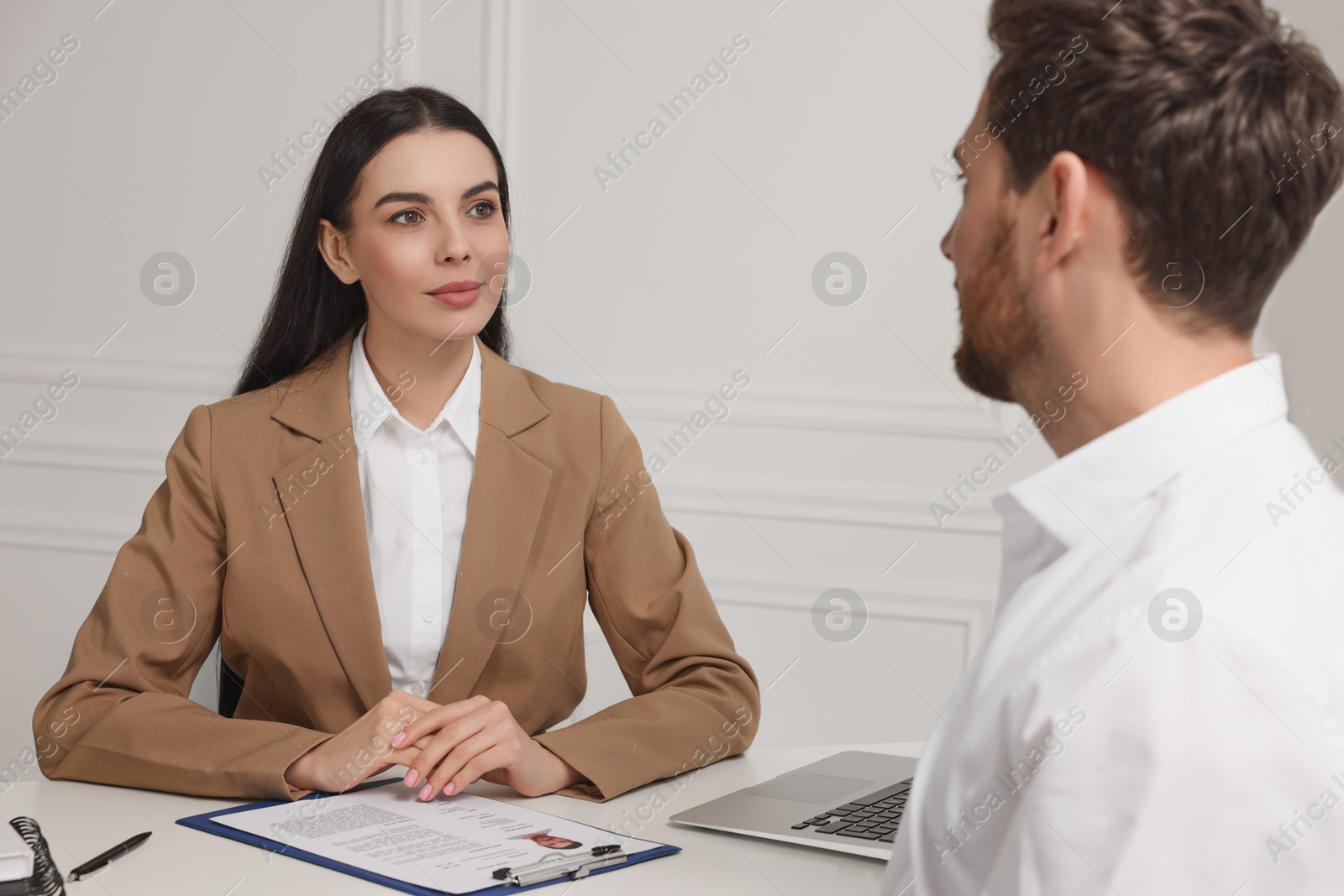 Photo of Human resources manager conducting job interview with applicant in office