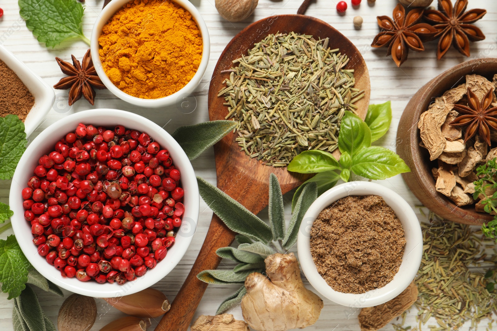 Photo of Different fresh herbs and spices on white wooden table, flat lay