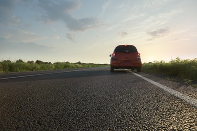 Photo of Road trip. Car driving on asphalt highway outdoors