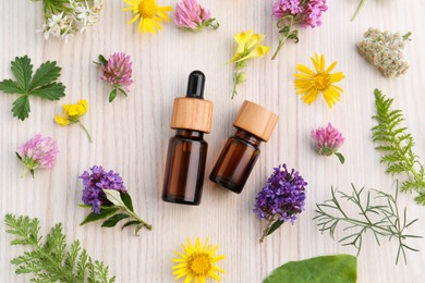 Photo of Flat lay composition with essential oil, flowers and herbs on white wooden table