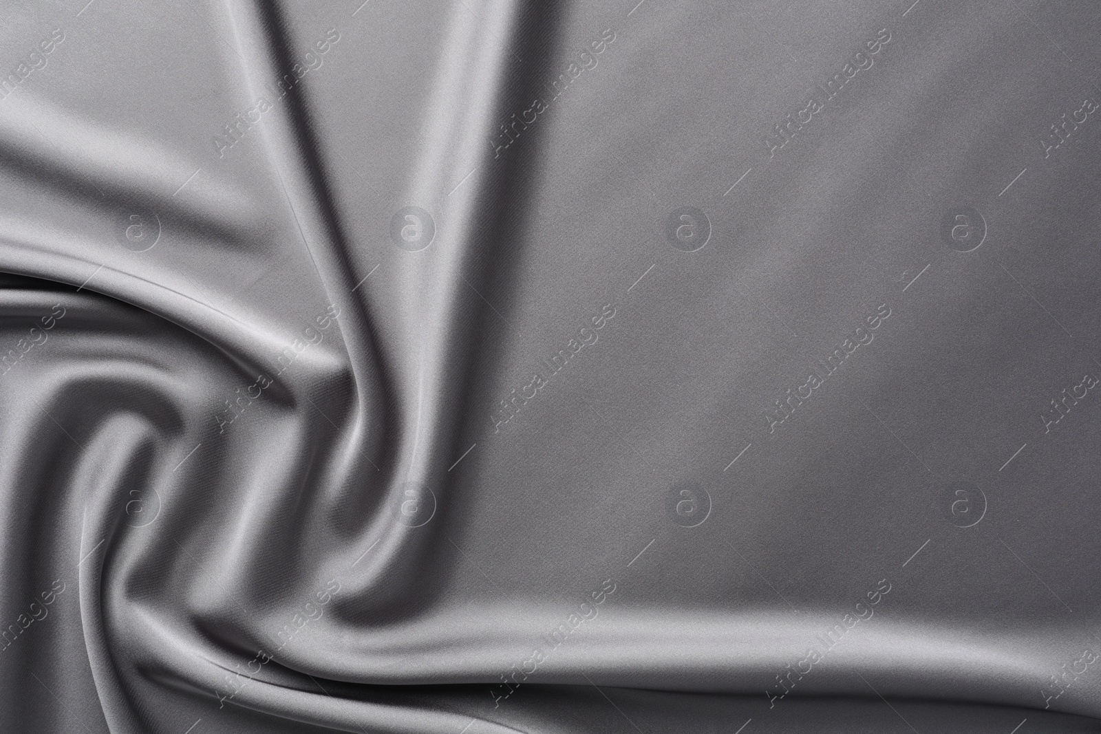 Photo of Texture of beautiful light grey silk fabric as background, closeup