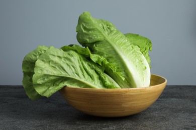 Photo of Fresh green romaine lettuces on grey table