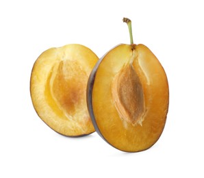 Halves of fresh ripe plum on white background