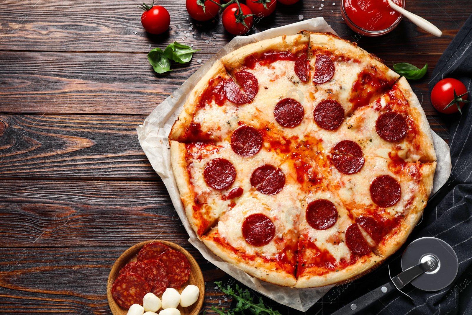 Photo of Flat lay composition with hot pepperoni pizza on wooden table