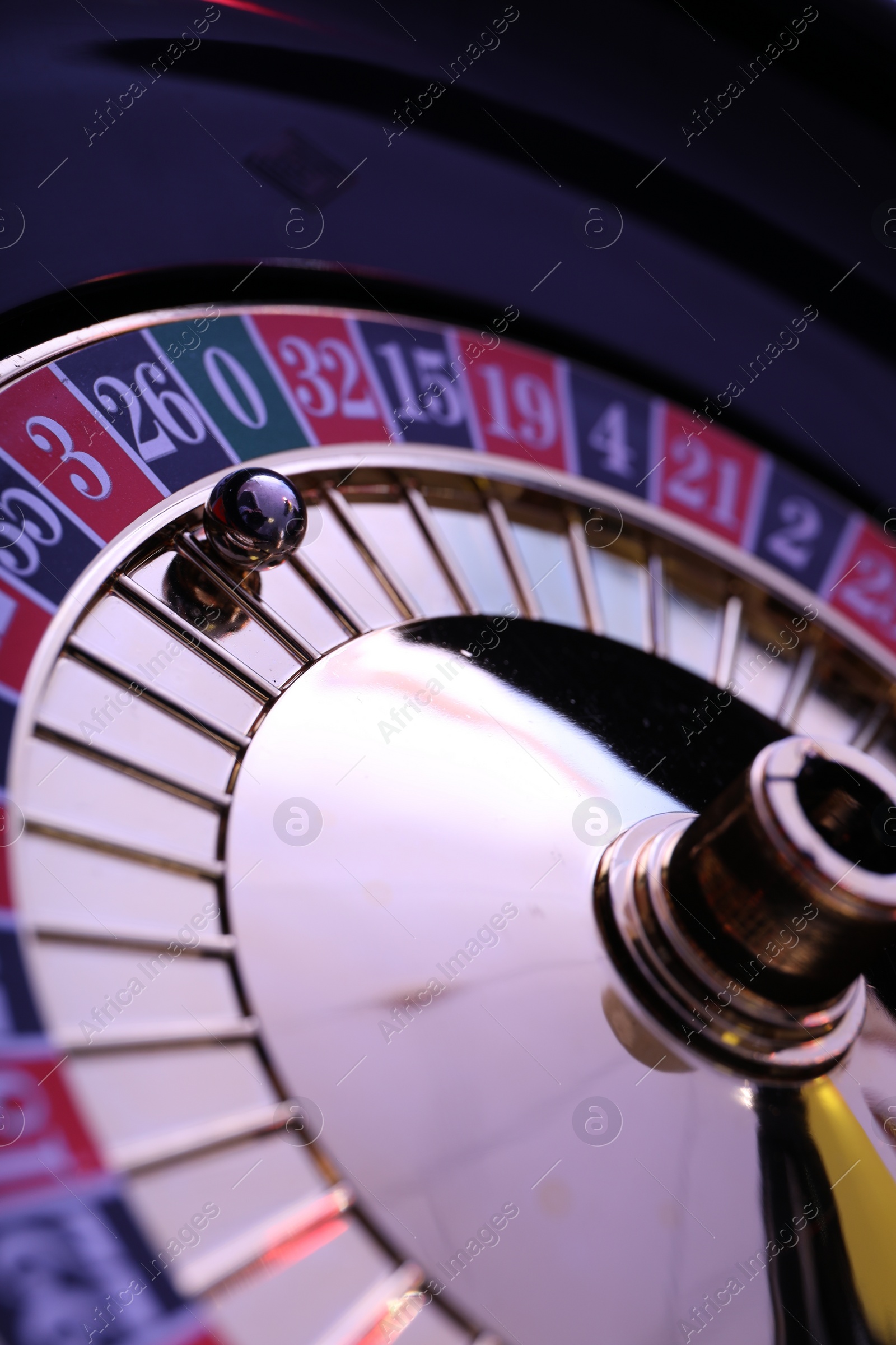 Photo of Roulette wheel with ball, closeup. Casino game