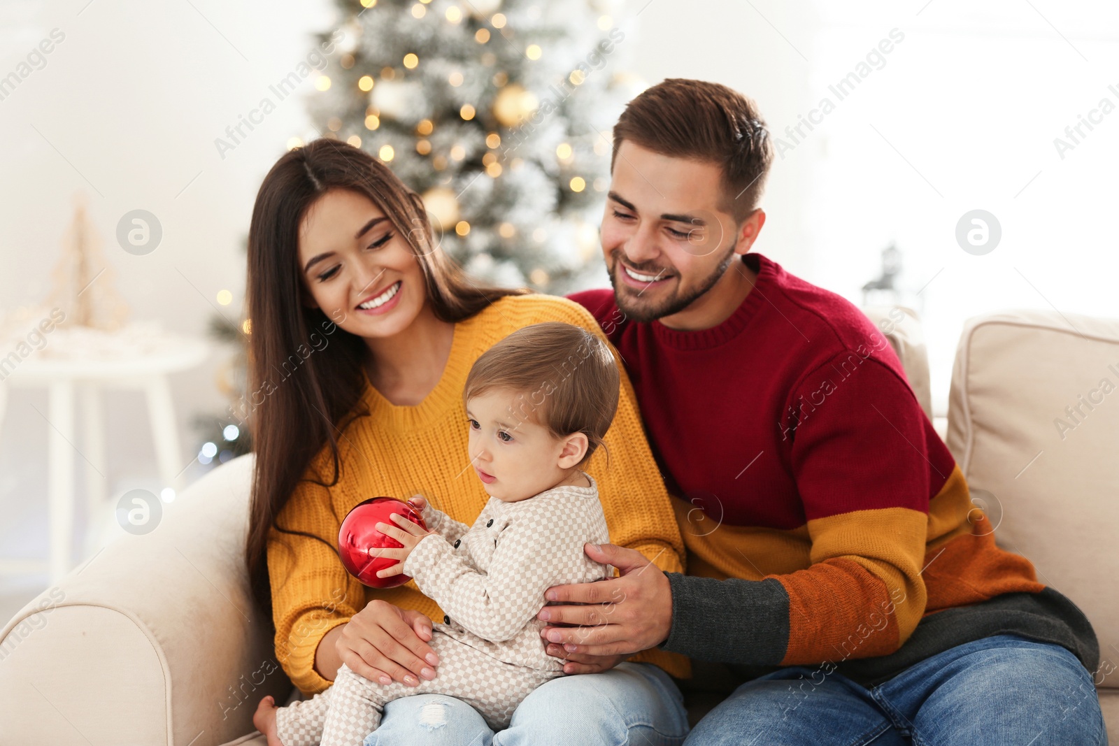 Photo of Happy family with cute baby at home. Christmas celebration