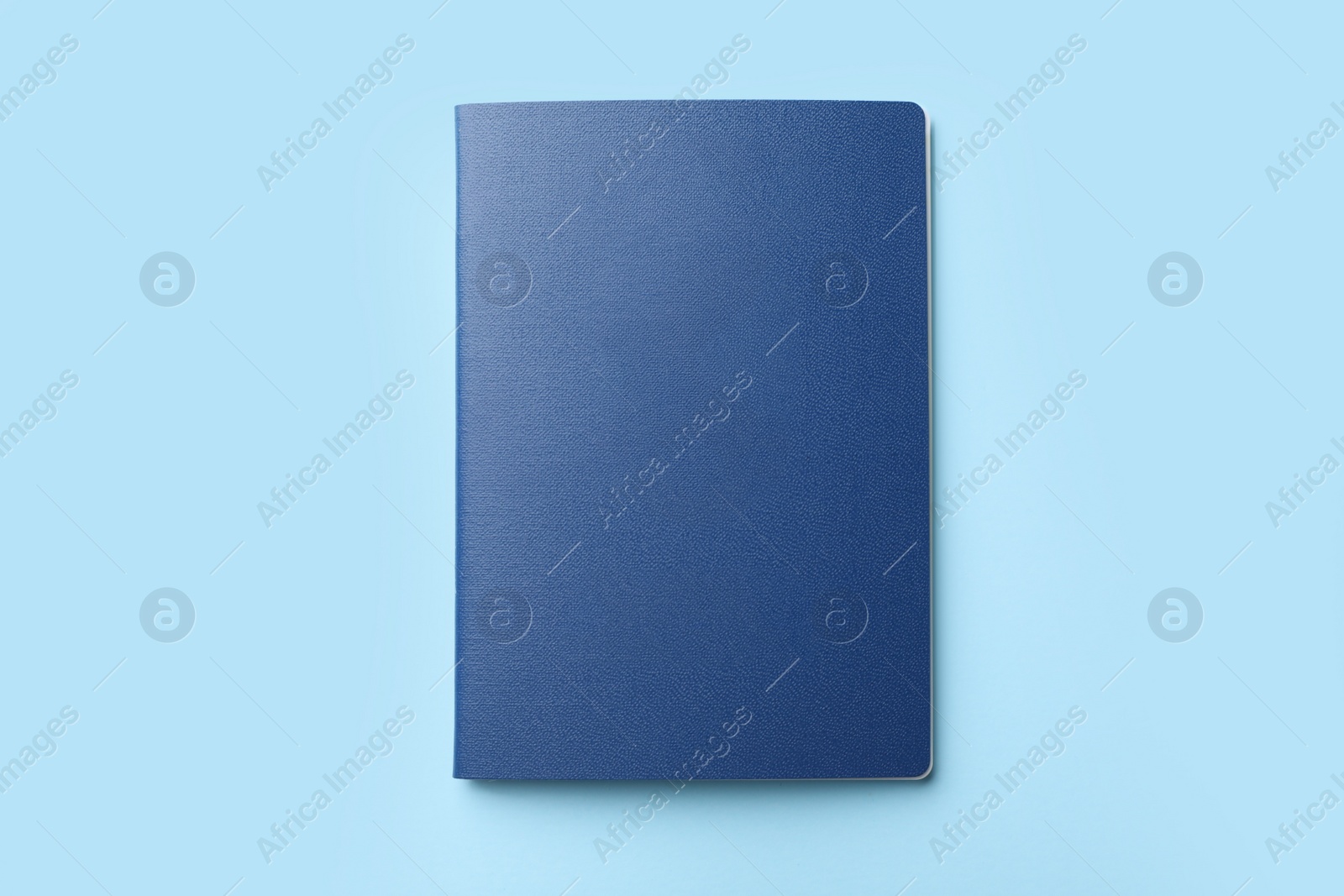 Photo of Blank passport on light blue background, top view