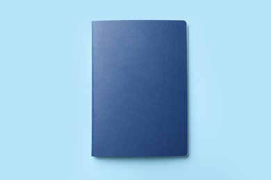 Blank passport on light blue background, top view