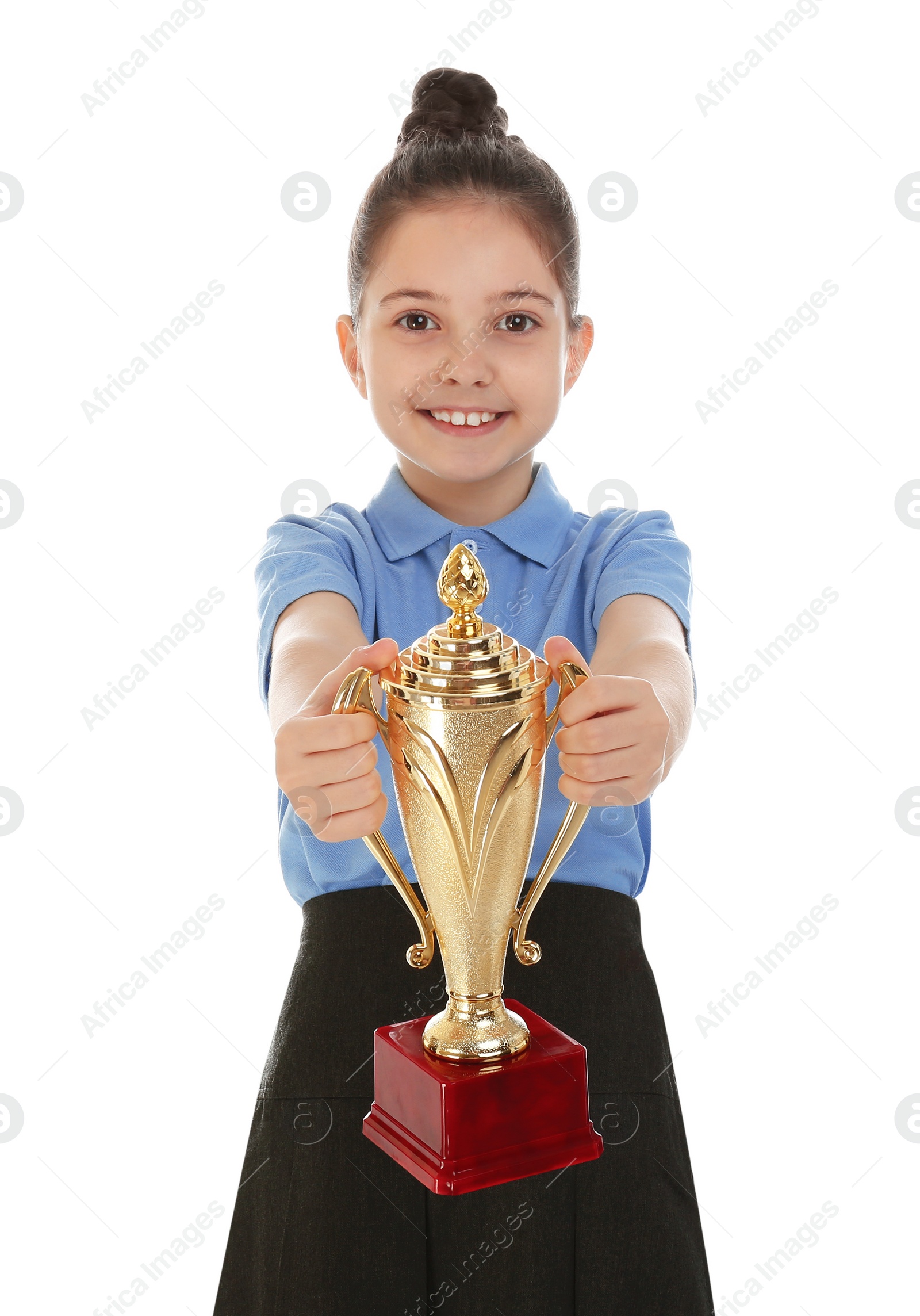 Photo of Happy girl in school uniform with golden winning cup isolated on white