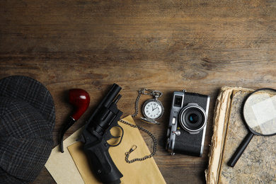 Photo of Flat lay composition with vintage detective items on wooden background, space for text