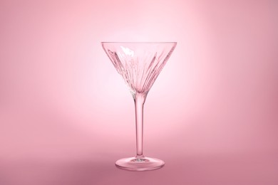 Photo of Elegant empty martini glass on pink background