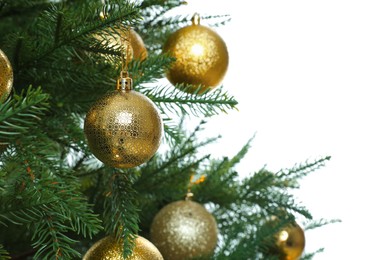 Photo of Christmas tree with golden baubles on white background, closeup