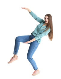 Young woman with magnet attracting people on white background