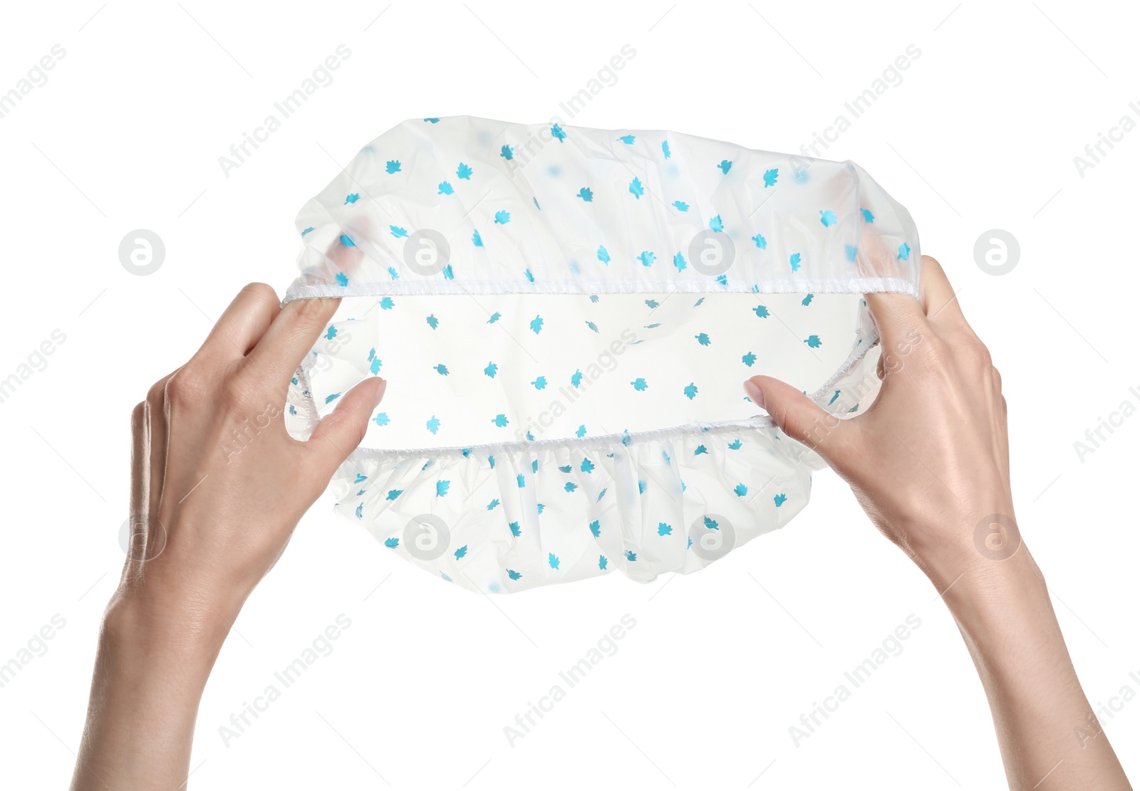 Photo of Woman holding shower cap with pattern on white background, closeup
