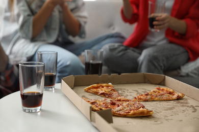 Photo of Friends eating pizza party indoors, closeup view