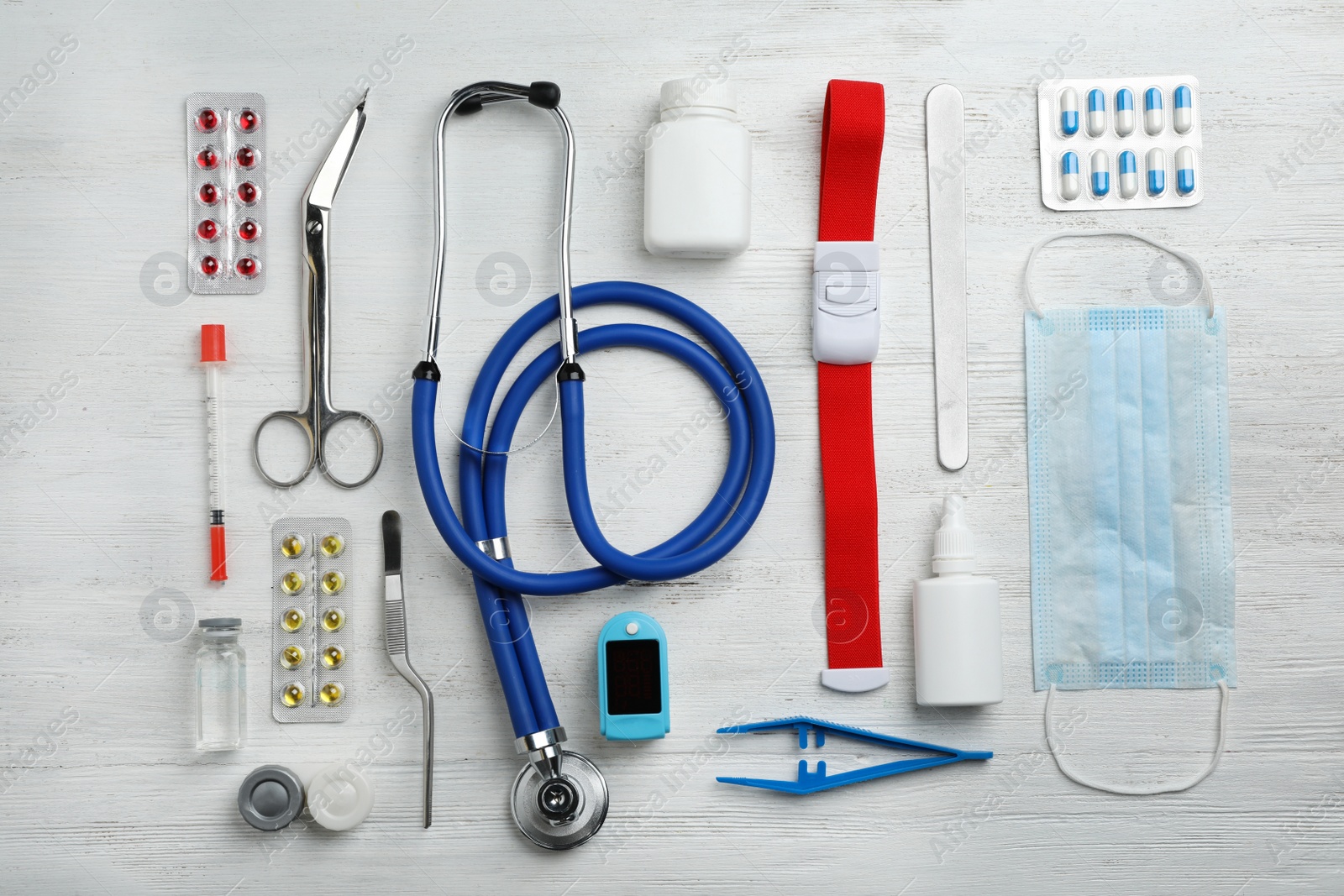 Photo of Flat lay composition with medical objects on white wooden background