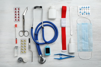 Flat lay composition with medical objects on white wooden background