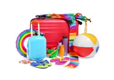 Photo of Suitcases, bright kite, inflatable ring and other beach accessories isolated on white