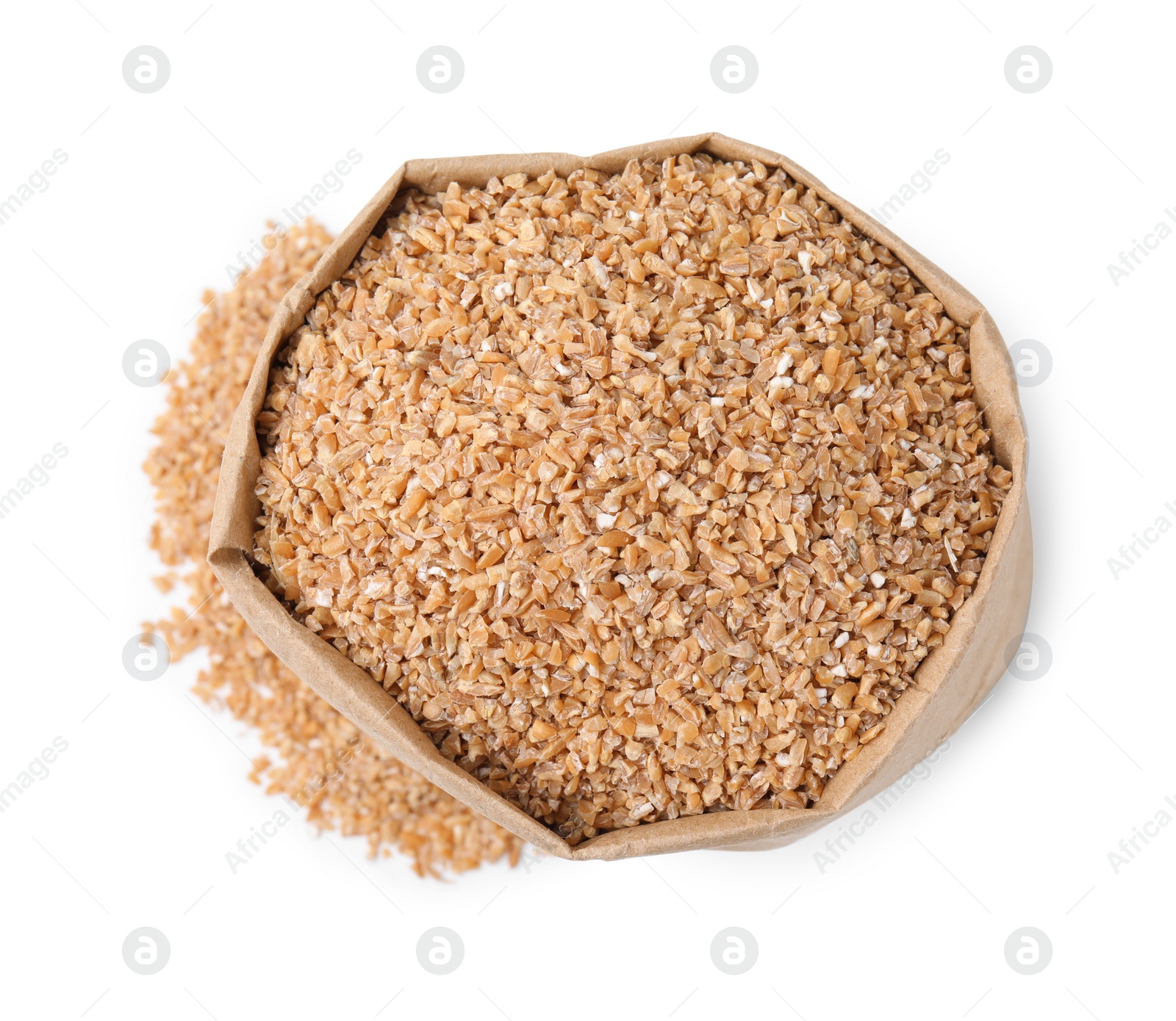 Photo of Dry wheat groats in paper bag isolated on white, top view