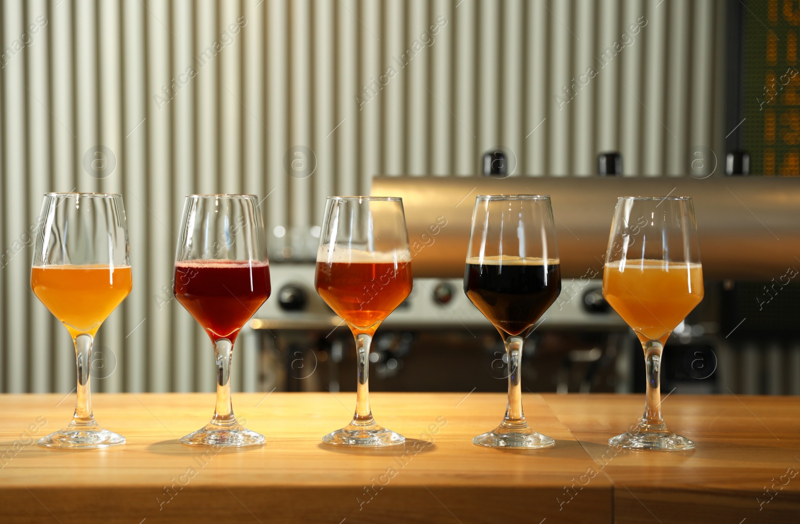 Photo of Different sorts of beer on wooden bar counter