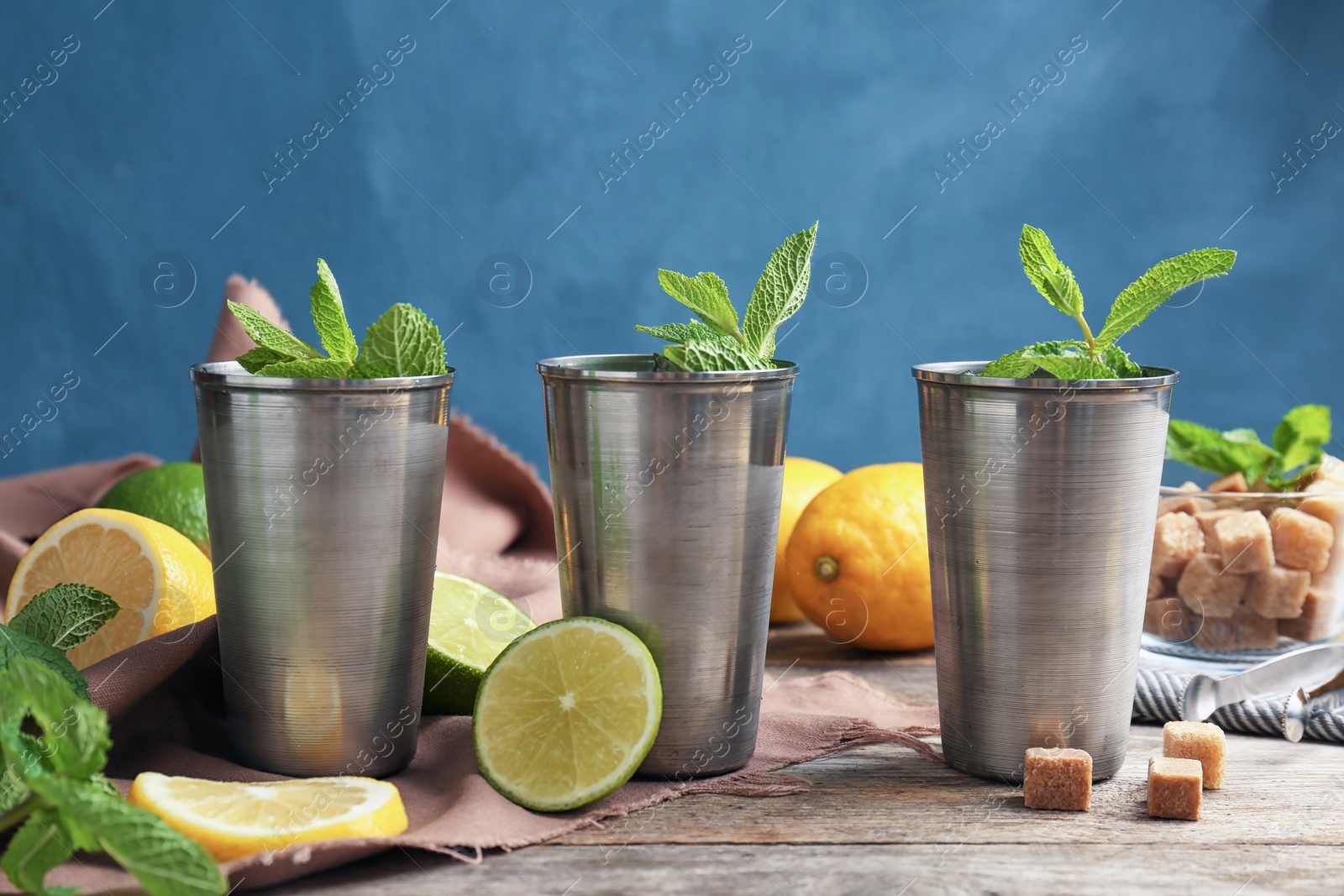 Photo of Composition with delicious mint julep cocktail on table